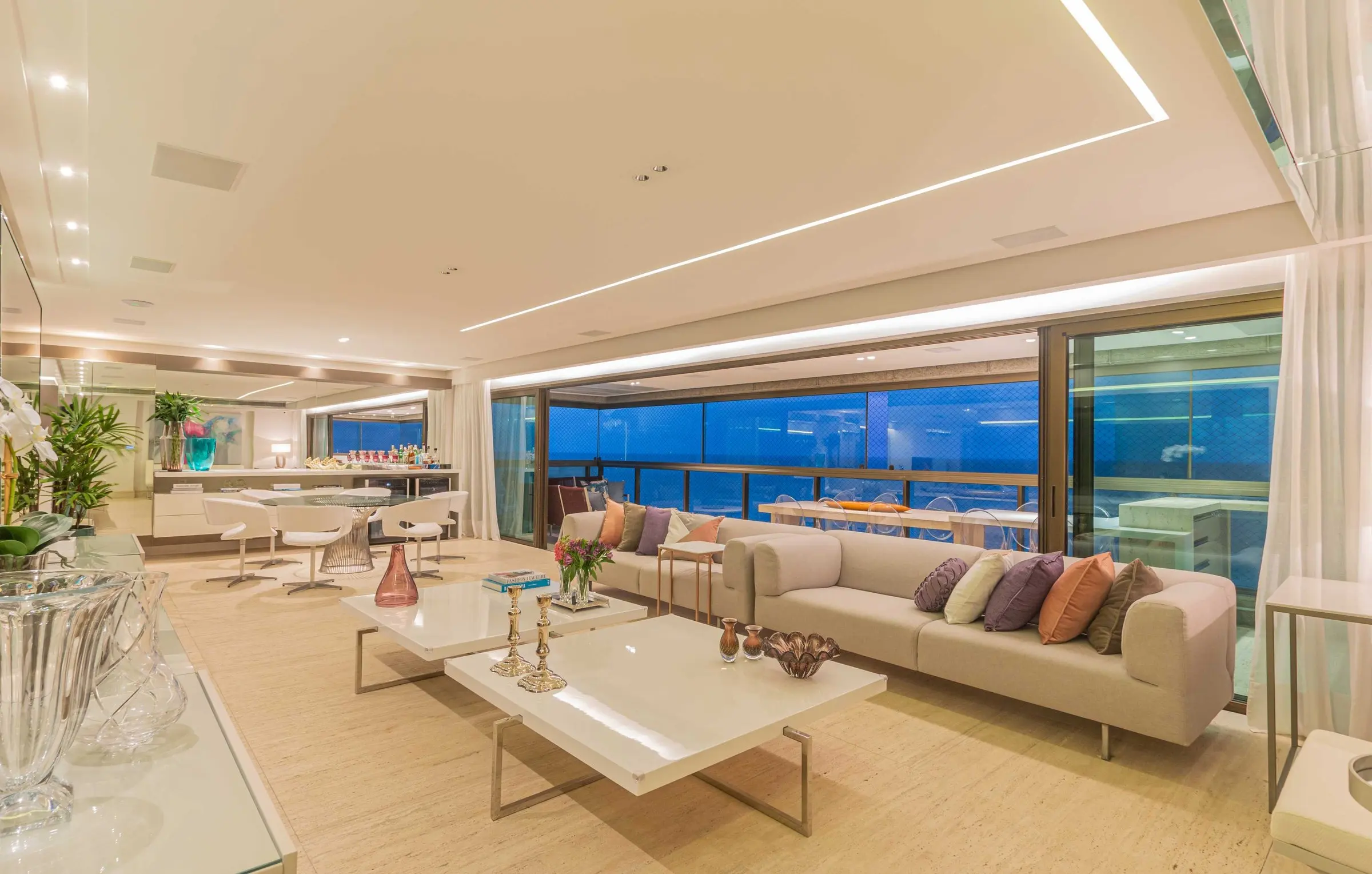 Spacious living area opening onto the glazed balcony with a sea view