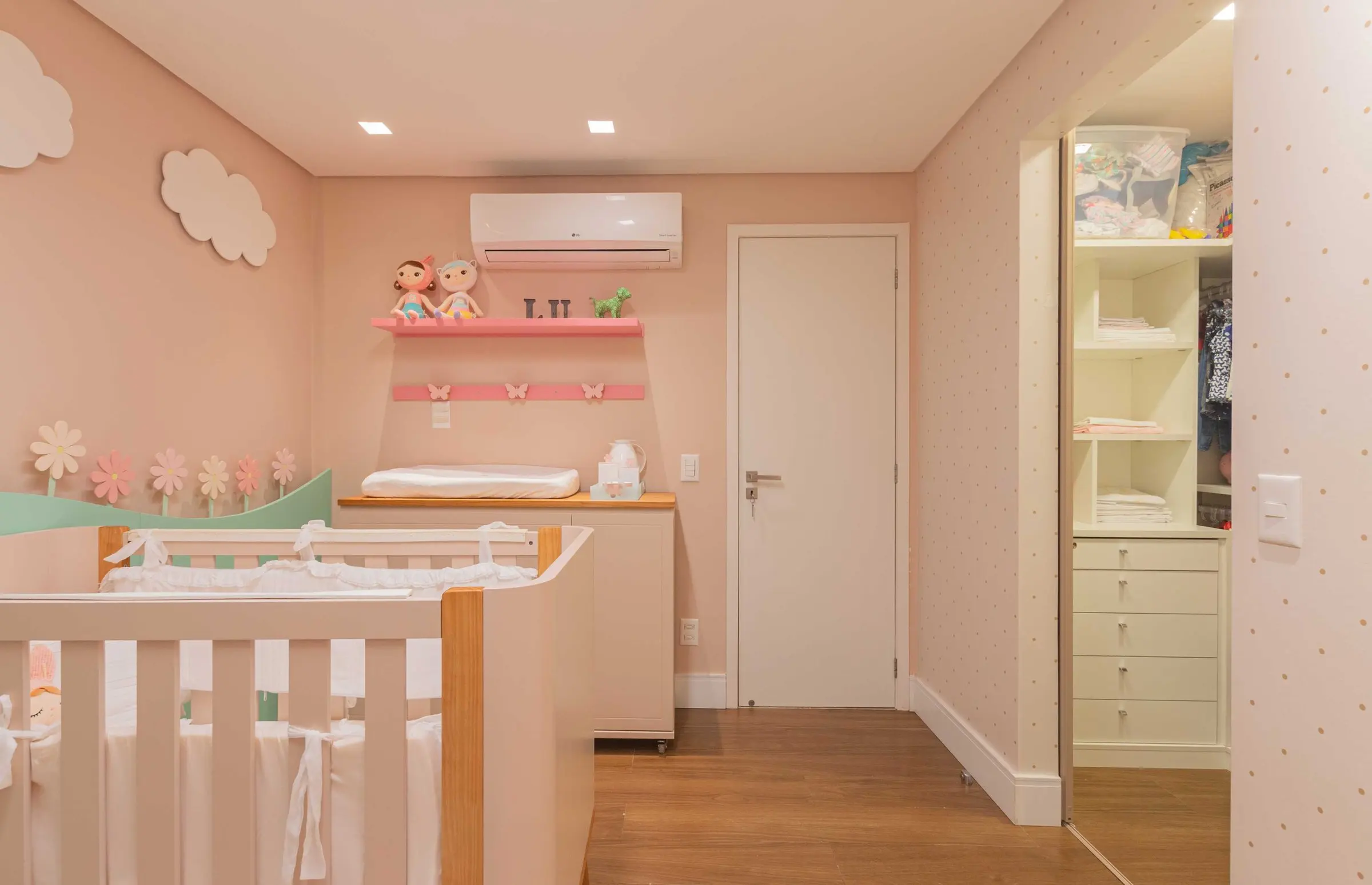 View of the crib, the door and the wardrobe