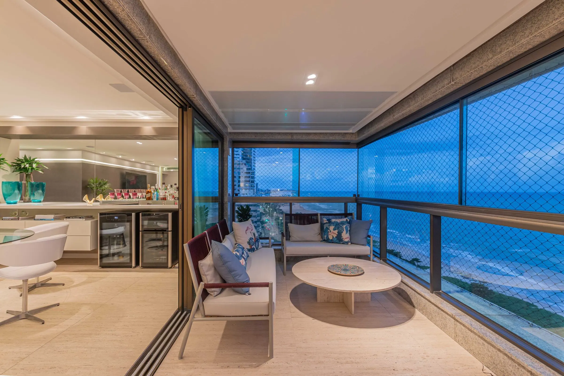 Balcony lounge with a round coffee table overlooking the beach