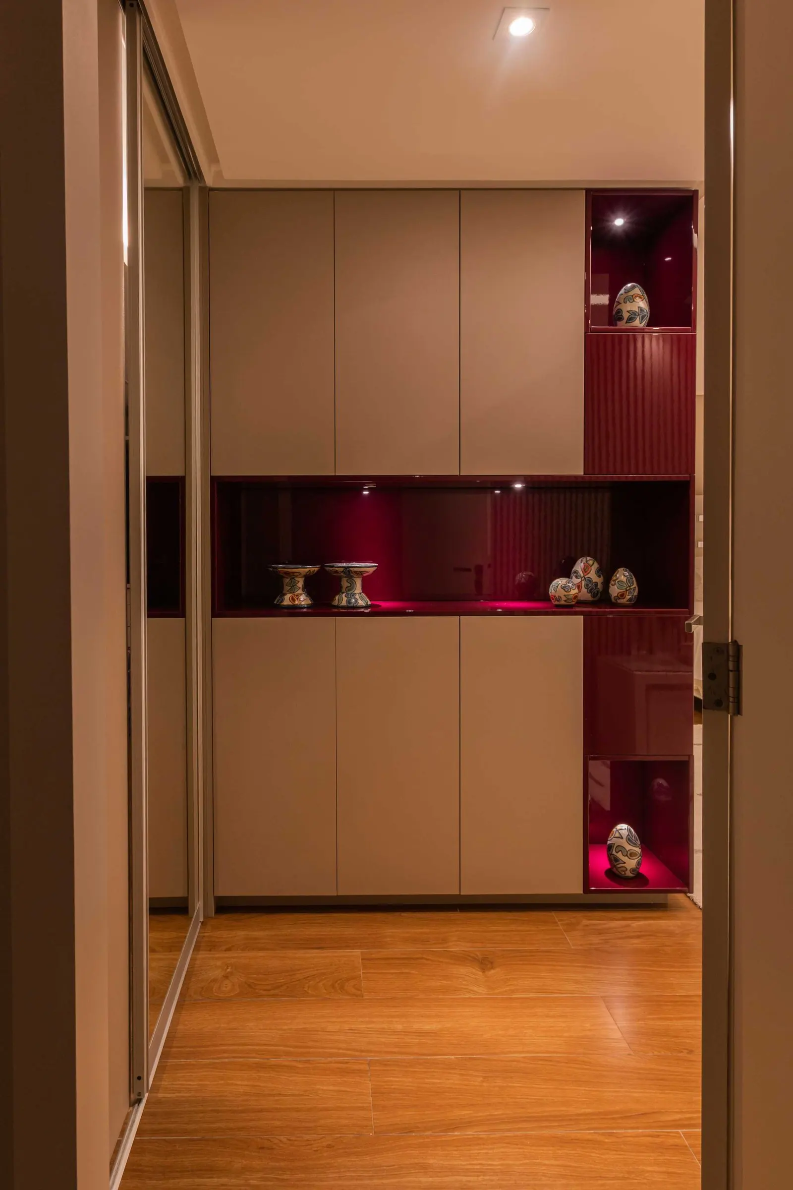Walk-in closet with red illuminated niches