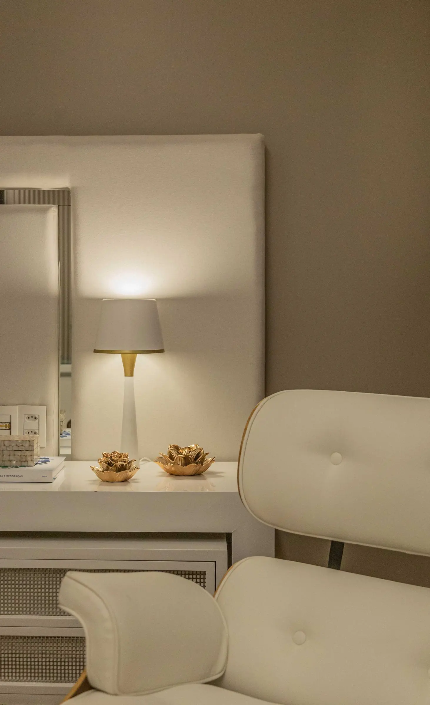 Detail of the upholstered headboard and lamp