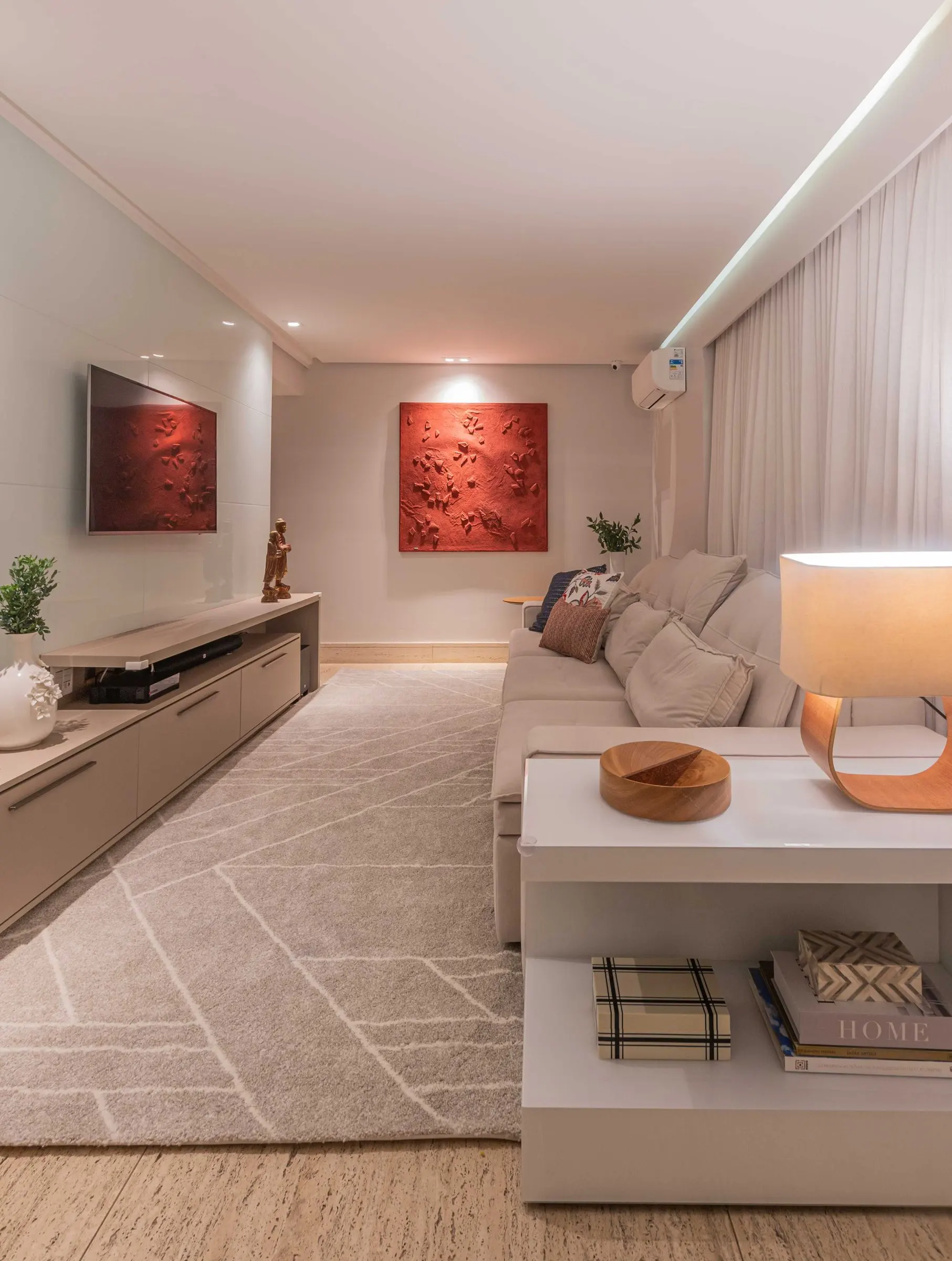 TV room with a light rug and indirect lighting
