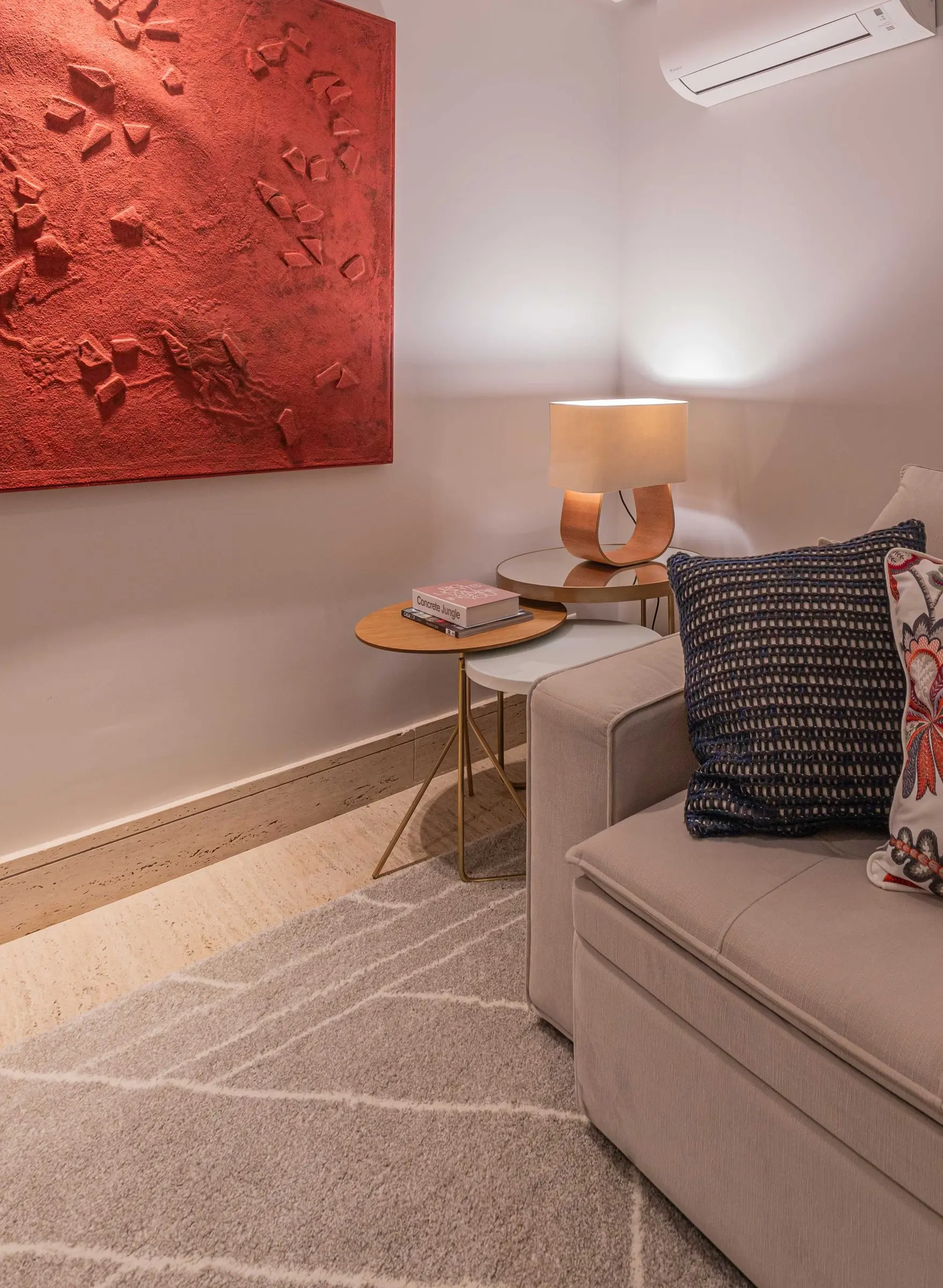 Corner of the TV room with a lamp and cushions
